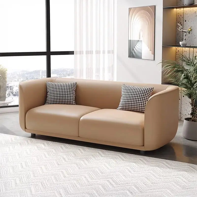 Lounge sofa with soft rounded arms and low wraparound backrest, wide-angle seating view