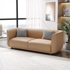 Lounge sofa with soft rounded arms and low wraparound backrest, wide-angle seating view