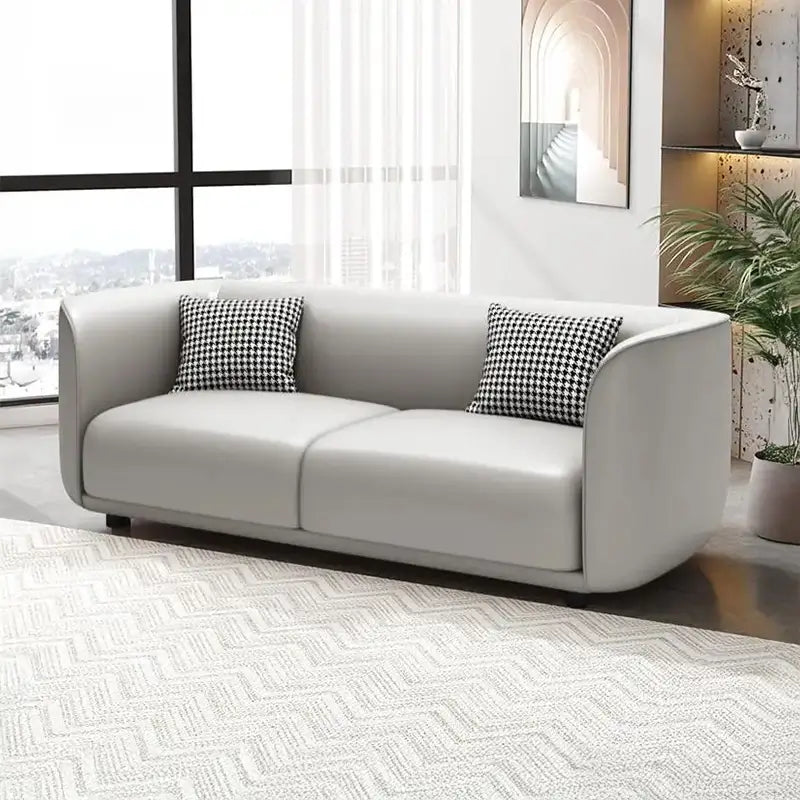 Curved sofa with soft rounded arms and low wraparound backrest, top-angle perspective