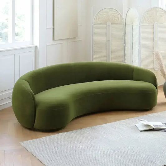 Curved sofa with wraparound backrest and deep bench seating, front three-quarter view