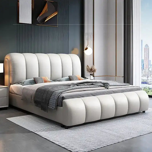 hydraulic bed shown in a spacious bed layout with curved padded headboard