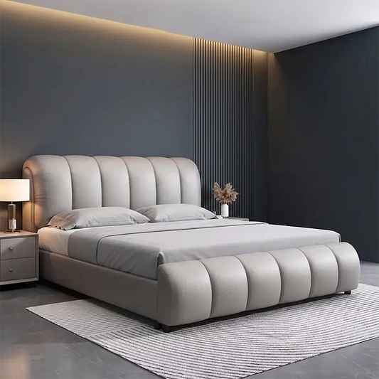 hydraulic bed shown in a spacious bed layout with curved padded headboard