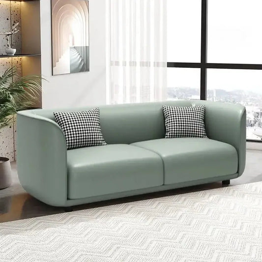 Lounge sofa with soft rounded arms and low wraparound backrest, front three-quarter view