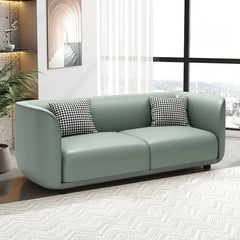Lounge sofa with soft rounded arms and low wraparound backrest, front three-quarter view