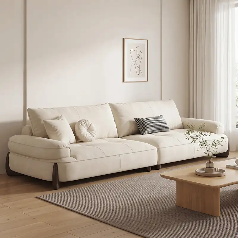 plush sofa with rounded cushioned armrests and low lounge profile, front perspective