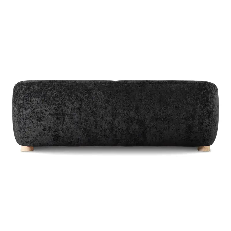 Boucle sofa with thick rounded arms and natural wooden legs, front corner perspective