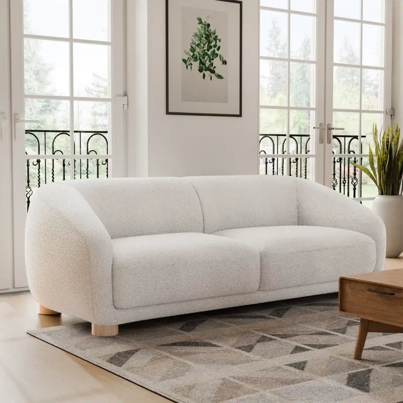 Fabric sofa with thick rounded arms and natural wooden legs, elevated base perspective