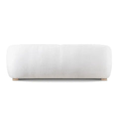 Fabric sofa with thick rounded arms and natural wooden legs, straight front view