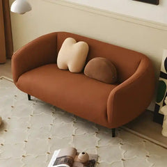 Luxury sofa with wraparound backrest and compact seating, straight front view