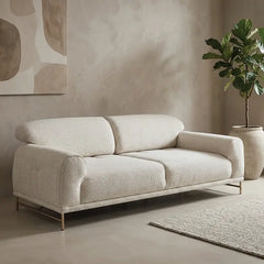 Boucle sofa with rounded cushioned arms and metallic legs, front three-quarter view
