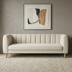 leatherette sofa with rounded arms and tapered wooden legs, side profile