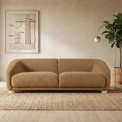 Fabric sofa with thick rounded arms and natural wooden legs, left-side view