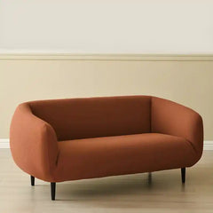 Curved sofa with wraparound backrest and compact seating, left-side view