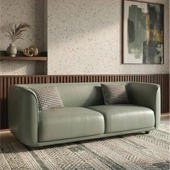 Lounge sofa with soft rounded arms and low wraparound backrest, left-side view
