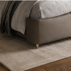 bed with tufted headboard side profile with cushioned frame edges with button-padded headboard