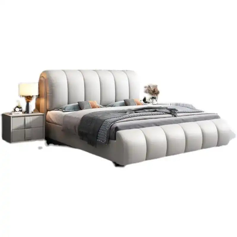 upholstered bed with hydraulic storage shown in a spacious bed layout with curved padded headboard