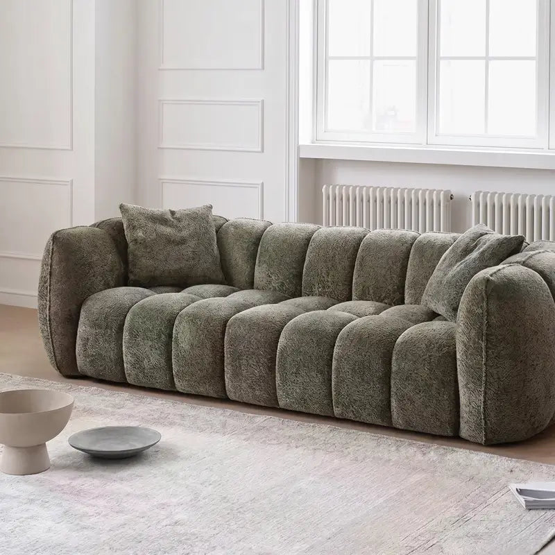 boucle sofa with side angle showing rounded arm support, upholstery close-up