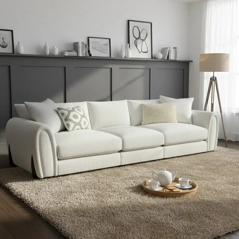 Corner sofa with curved arms and wooden accent details, close-up of back cushions