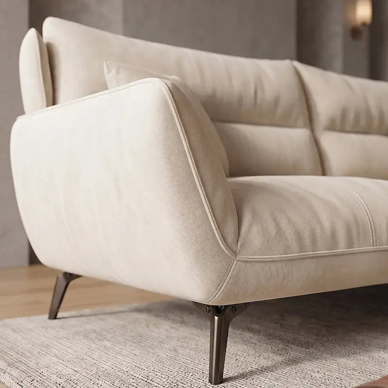 L shape sofa with soft curved arms and slim metal legs, close-up of back cushions
