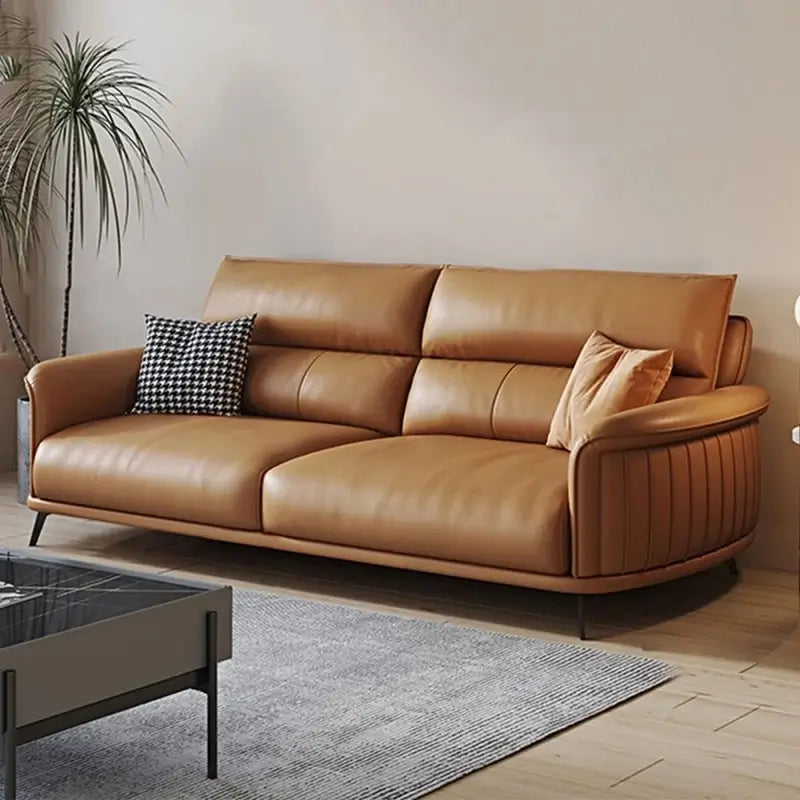 Modern living room with a beige and brown sofa, coffee table, and decorative elements.