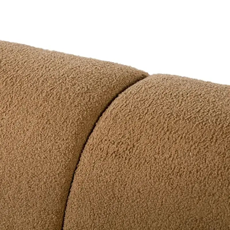 Boucle sofa with thick rounded arms and natural wooden legs, leg and base detail