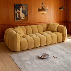 3 seater fabric sofa with rounded armrests with integrated plush cushioning, raised base view