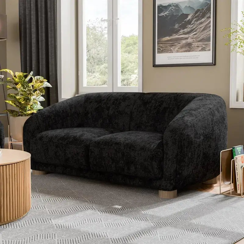 Fabric sofa with thick rounded arms and natural wooden legs, lounger configuration view