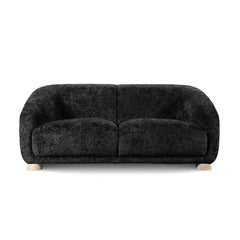 Boucle sofa with thick rounded arms and natural wooden legs, backrest support detail