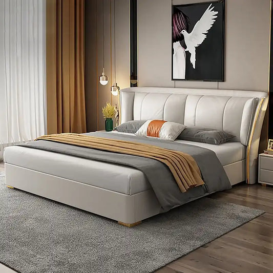 queen size upholstered bed shown in a spacious bed layout with wide padded headboard