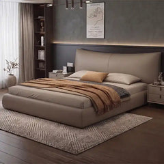 minimalist platform bed shown in a spacious bed layout with curved padded headboard