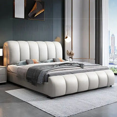 hydraulic bed shown in a spacious bed layout with curved padded headboard