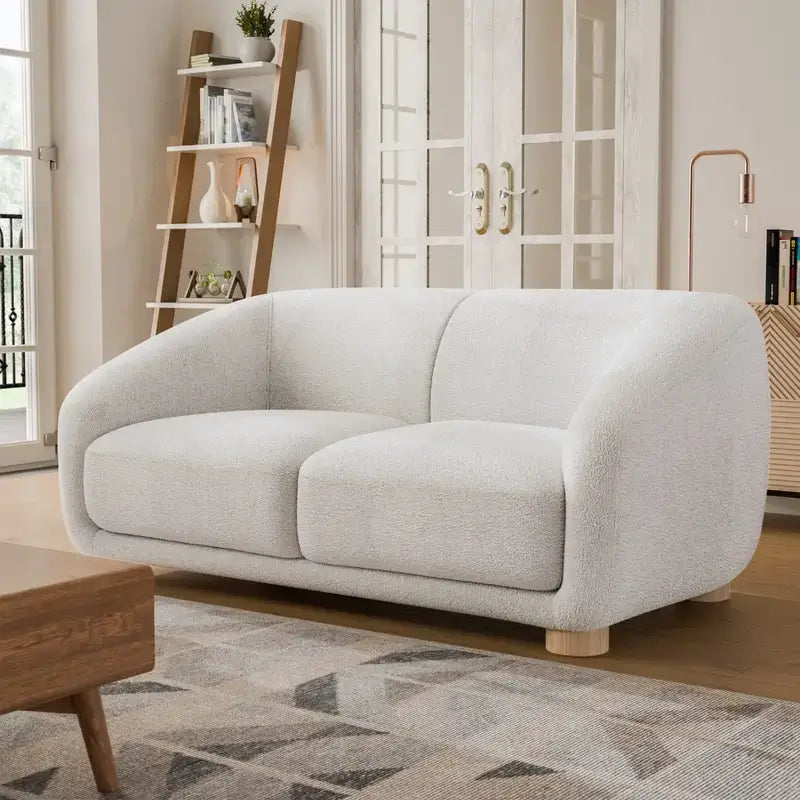 Fabric sofa with thick rounded arms and natural wooden legs, full-length view
