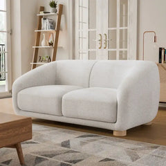 Fabric sofa with thick rounded arms and natural wooden legs, full-length view