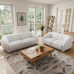 Boucle sofa with thick rounded arms and natural wooden legs, cushion and arm detail