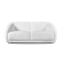 Fabric sofa with thick rounded arms and natural wooden legs, room-setting perspective