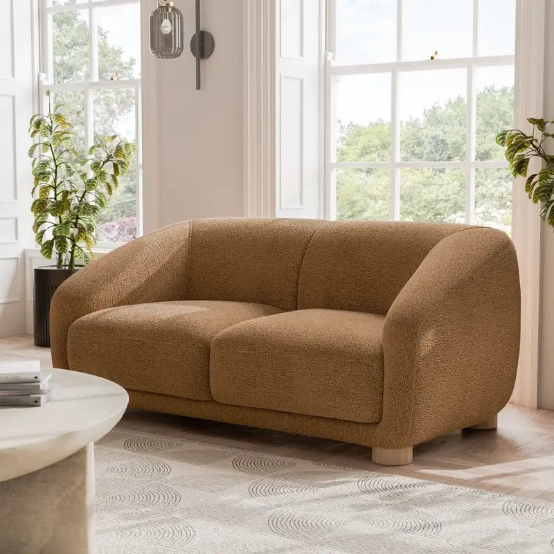 Fabric sofa with thick rounded arms and natural wooden legs, right-side view