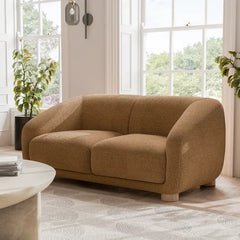 Fabric sofa with thick rounded arms and natural wooden legs, right-side view