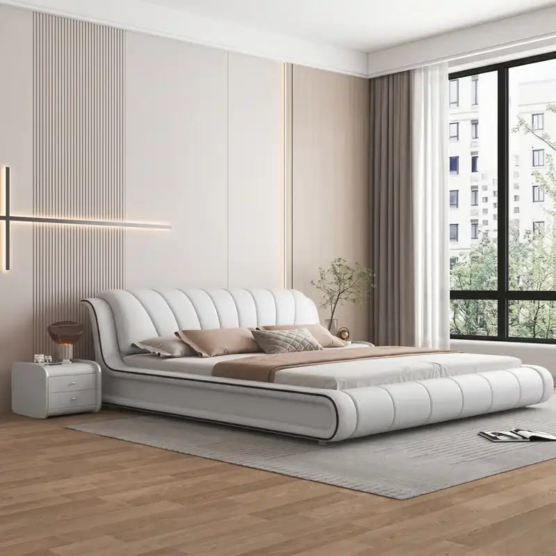 upholstered bed side view showing the upholstered frame and legs with curved padded headboard