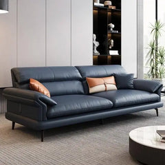 leatherette sofa with wide pillow-top armrests and thick back cushions, three-quarter view