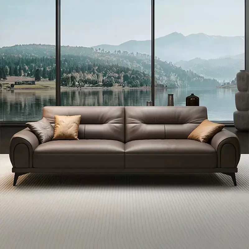 Leatherette sofa with rounded padded arms and elevated legs, straight front view
