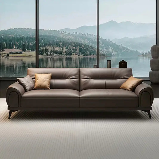 Leatherette sofa with rounded padded arms and elevated legs, straight front view