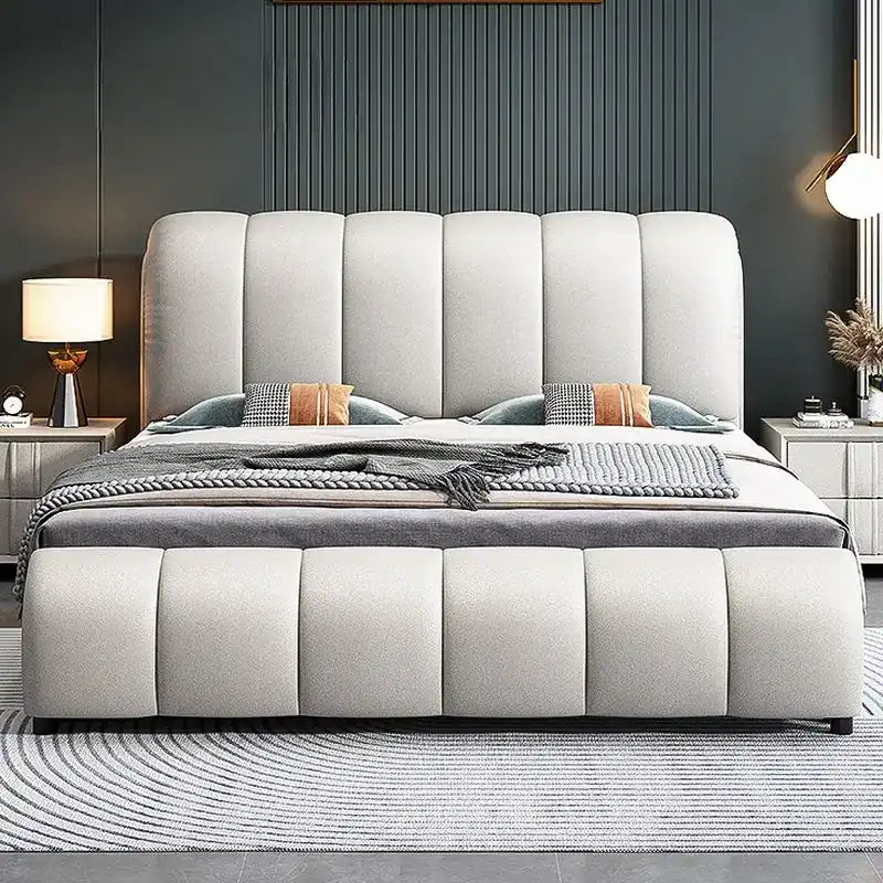 upholstered bed with hydraulic storage shown with a balanced mattress layout with curved padded headboard