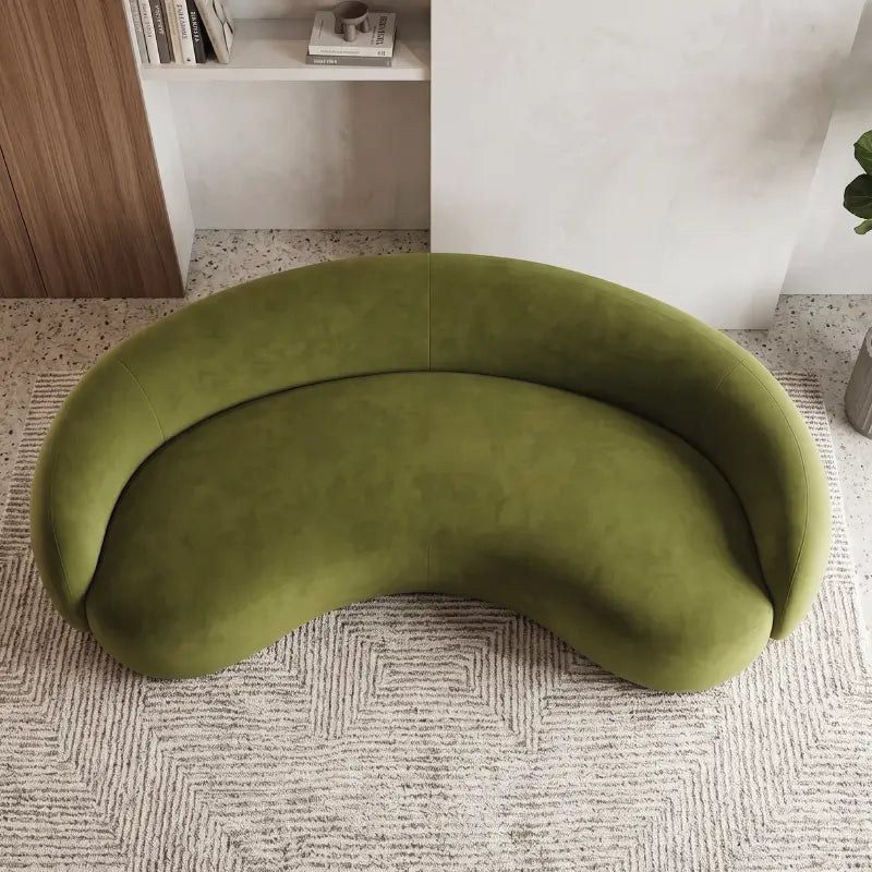 Curved sofa with wraparound backrest and deep bench seating, left-side view