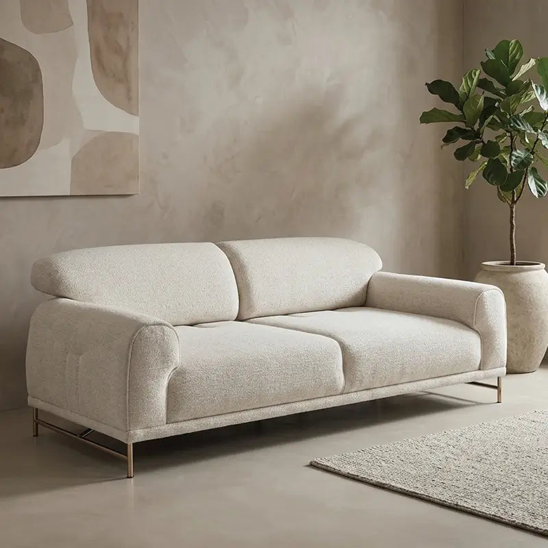 Boucle sofa with rounded cushioned arms and metallic legs, front three-quarter view