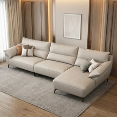 leatherette sofa with wide angular padded armrests and slim metal legs, side profile