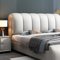 hydraulic bed shown in a spacious bed layout with curved padded headboard alternate front angle