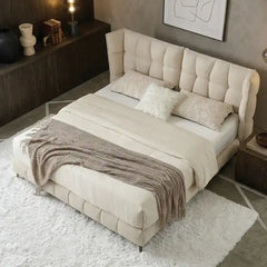 upholstered bed with storage shown in a spacious bed layout with thick padded headboard alternate front angle