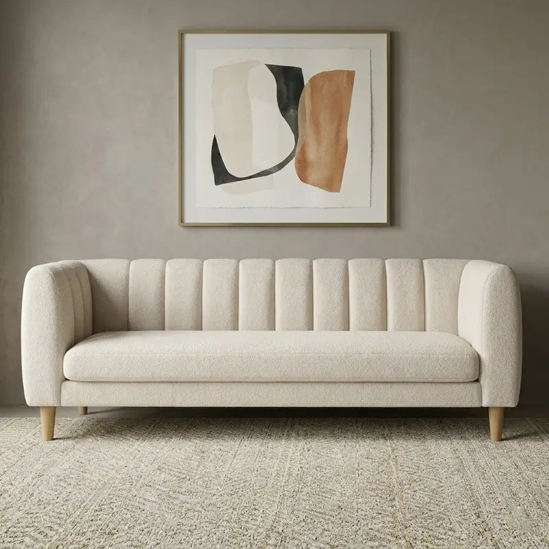 leatherette sofa with rounded arms and tapered wooden legs, side profile