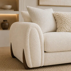 Corner sofa with curved arms and wooden accent details, left-side view