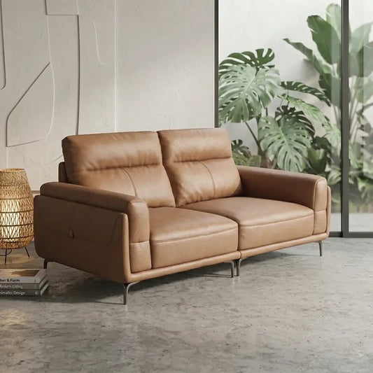 Leatherette sofa with wide padded arms and elevated metal legs, left-side view